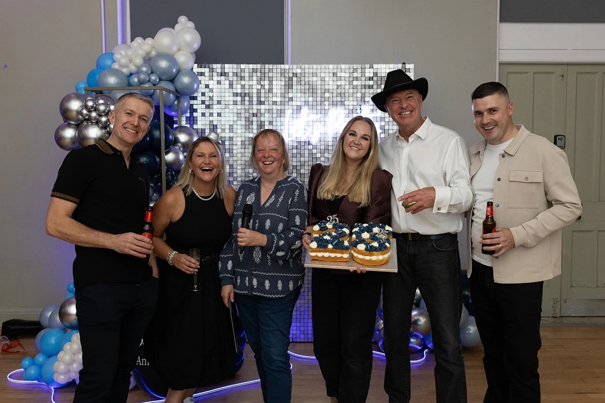 The Bluestorm directors and Managing Director holding a special 25 cake at the celebration party